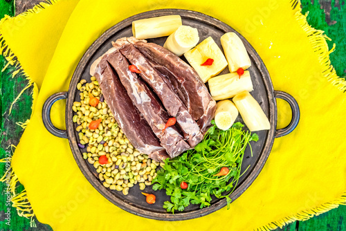 Traditional rustic tropical Brazilian dish, sun-dried beef with green beans, cassava, biquinho pepper. Creative rustic photography photo