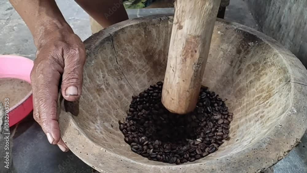 Traditional Coffee Bean Grinding in Wooden Mortar Traditional Coffee Bean Grinding in Wooden Mortar