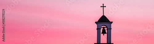 A timeworn church bell tower silhouetted against a dramatic sunset sky
