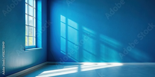 Sunlight casting shadows in room corner with blue wall creating dramatic effect