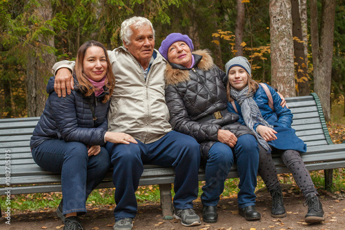 Portrait of family relaxing outdoor in autumn