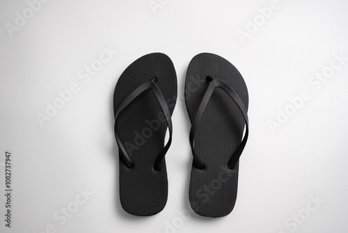 A pair of new black flip-flops or sandals.