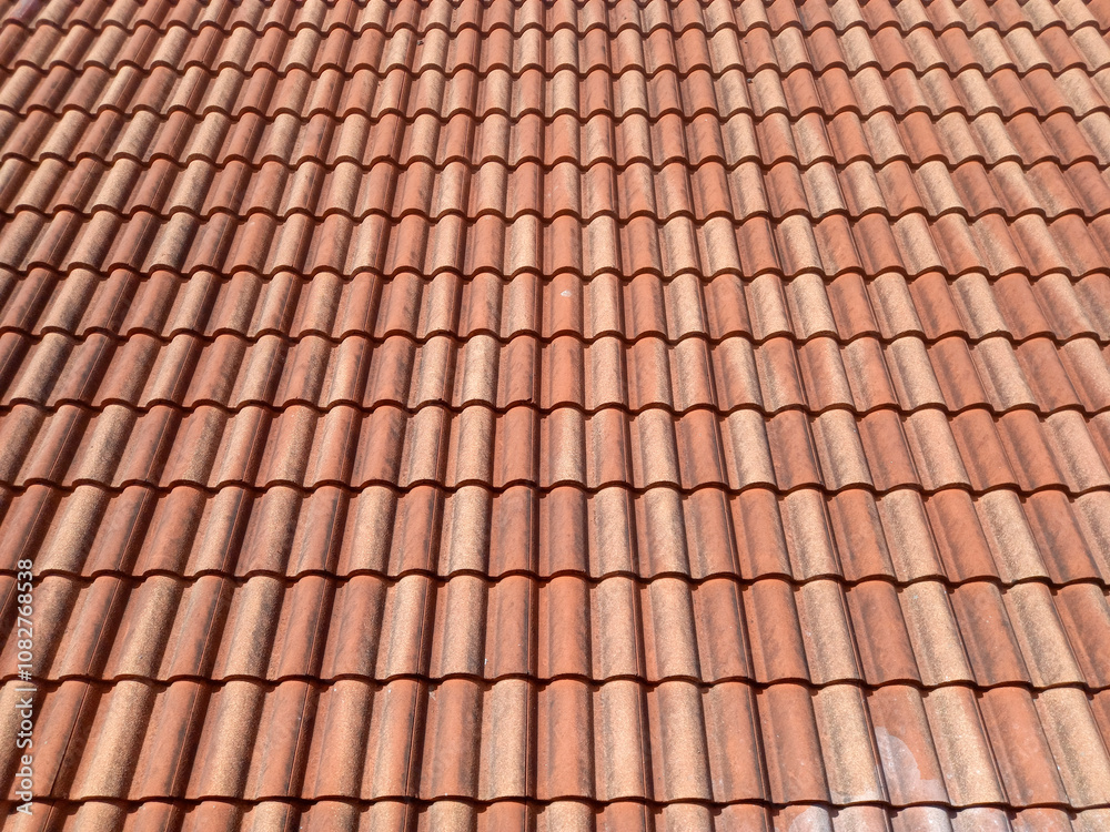 roof covered with terracotta tiles. The tiles are arranged in a uniform, overlapping pattern, creating a visually appealing and functional surface. The terracotta tiles are reddish-brown in color. roof covered with terracotta tiles. The tiles are arranged in a uniform, overlapping pattern, creating a visually appealing and functional surface. The terracotta tiles are reddish-brown in color.