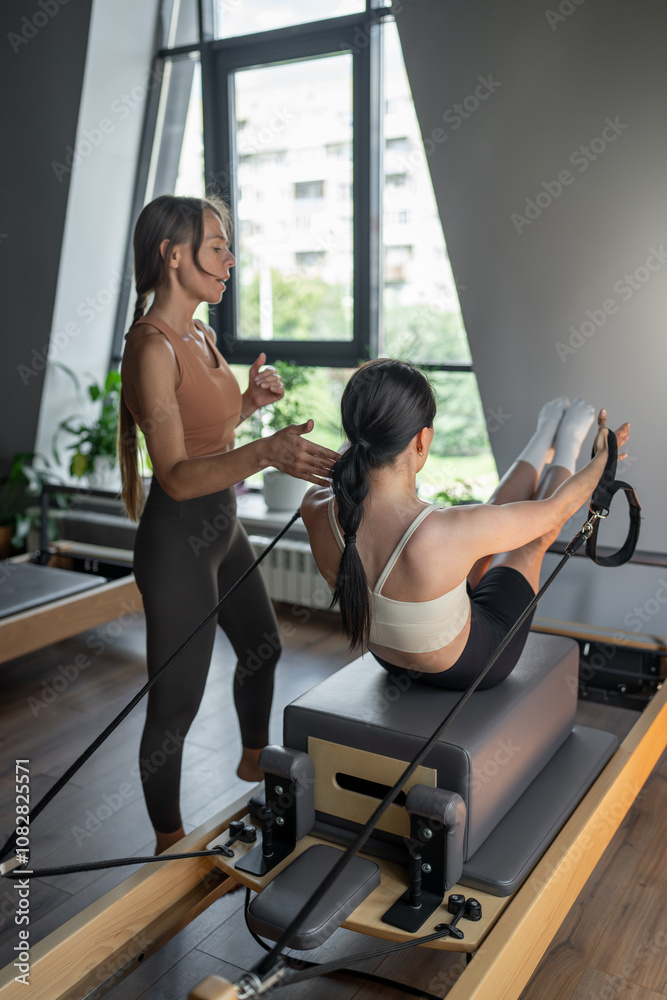 Modern Pilates studio with bright, spacious windows for exercise and wellbeing Modern Pilates studio with bright, spacious windows for exercise and wellbeing
