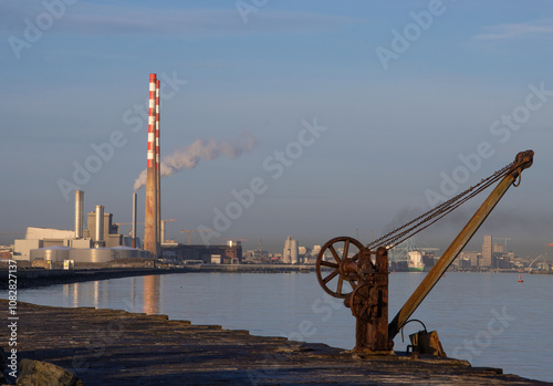 Photography old poolbeg power station chimneys and rusty metal crane, taken from great south