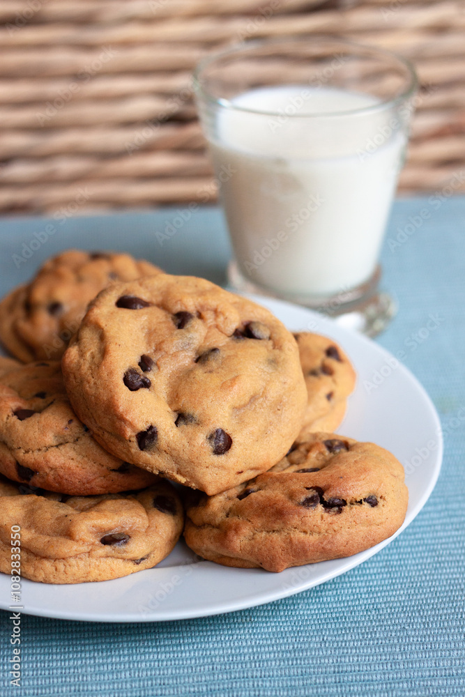 Plate of chocolate chip cookies and glass of milk Plate of chocolate chip cookies and glass of milk