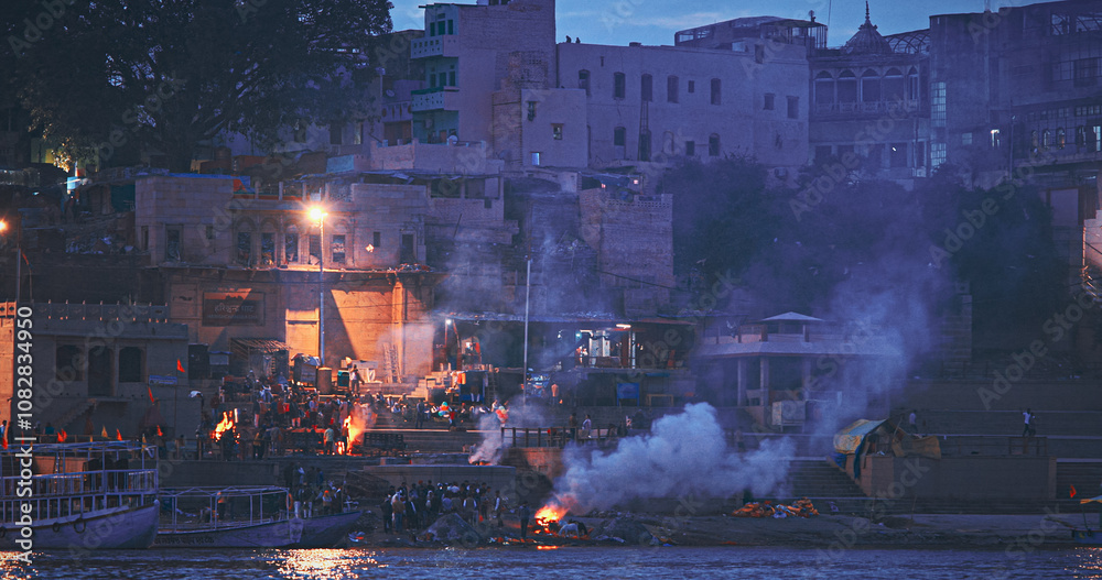 Varanasi, India. Funeral Rites Of Cremation At Harishchandra Ghat. Harishchandra Ghat Is One Of Only Two Ghats Serving As Cremation Sites Along Ganges River. Fire That Never Stops Sends Souls To