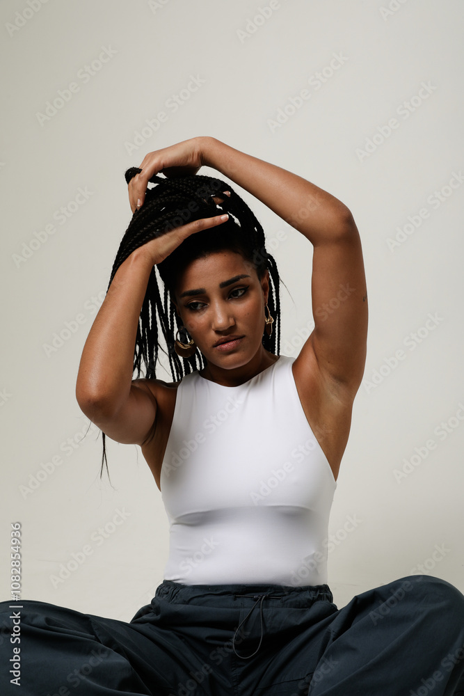 African American young woman with long dark braids looking at the ...