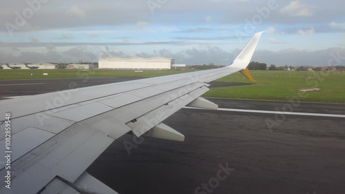 airplane lining up runway for takeoff from passenger's window seat perspective insight into departure process airport panning shot aviation flight commercial boarding travel path 
