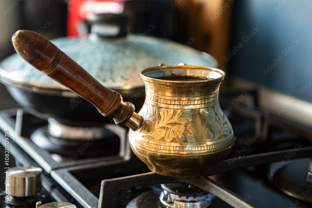Close up shot of preparation of turkish coffee using copper cezve on the gas stove Close up shot of preparation of turkish coffee using copper cezve on the gas stove