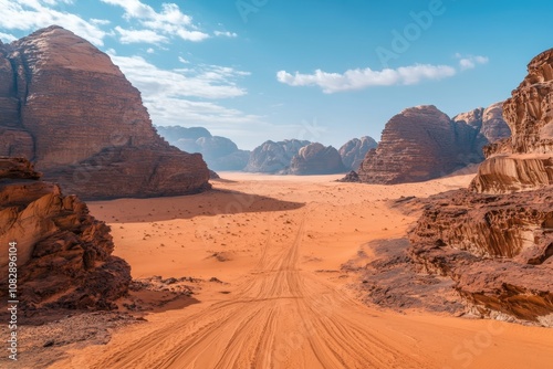 Majestic desert landscape with towering rock formations under a clear blue sky in Wadi Rum