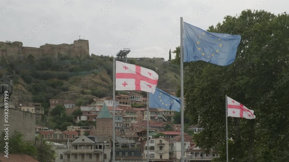 Flags of Georgia and European Union waving in square in Tbilisi. Flags of Georgia and European Union waving in square in Tbilisi.