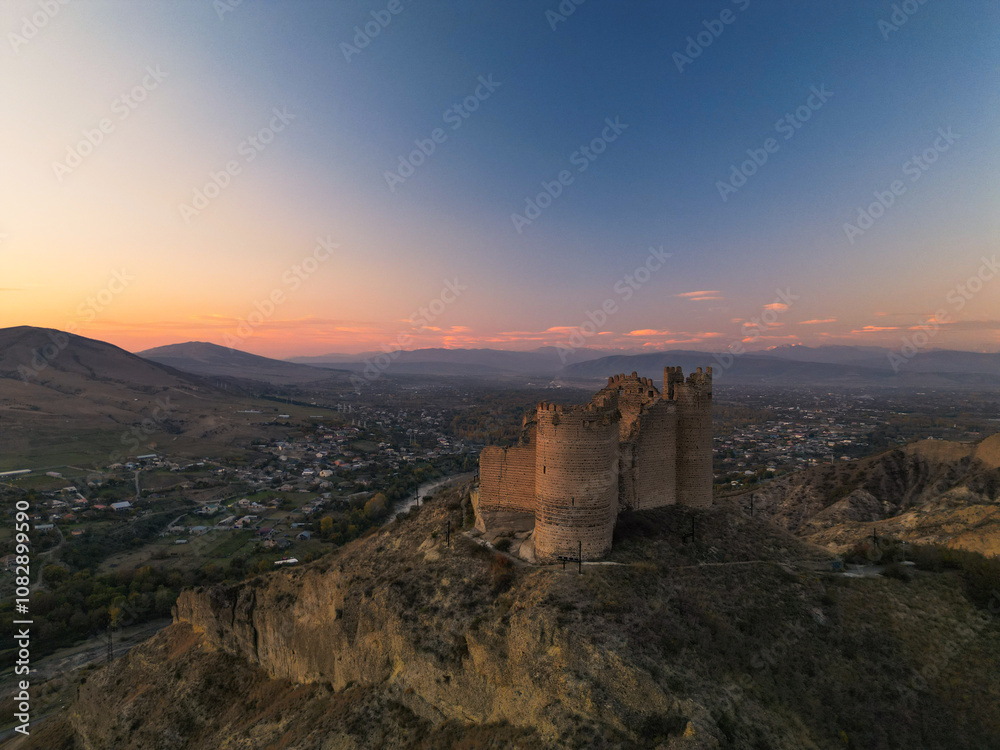 Fantasy breathtaking castle on top of mountain at sunset in Georgia Ksani Fantasy breathtaking castle on top of mountain at sunset in Georgia Ksani