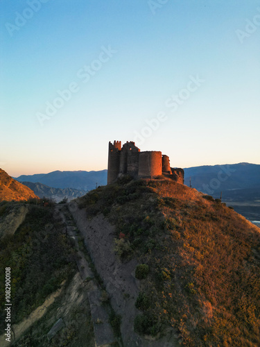  Fantasy breathtaking castle on top of mountain at sunset in Georgia Ksani photo