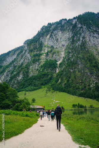 Konigssee Lake in Bavaria Germany with Church by the Lake White Boat Forested Mountain and Beautiful Sunny Trekking in Berchtesgaden German Alps. High quality photo