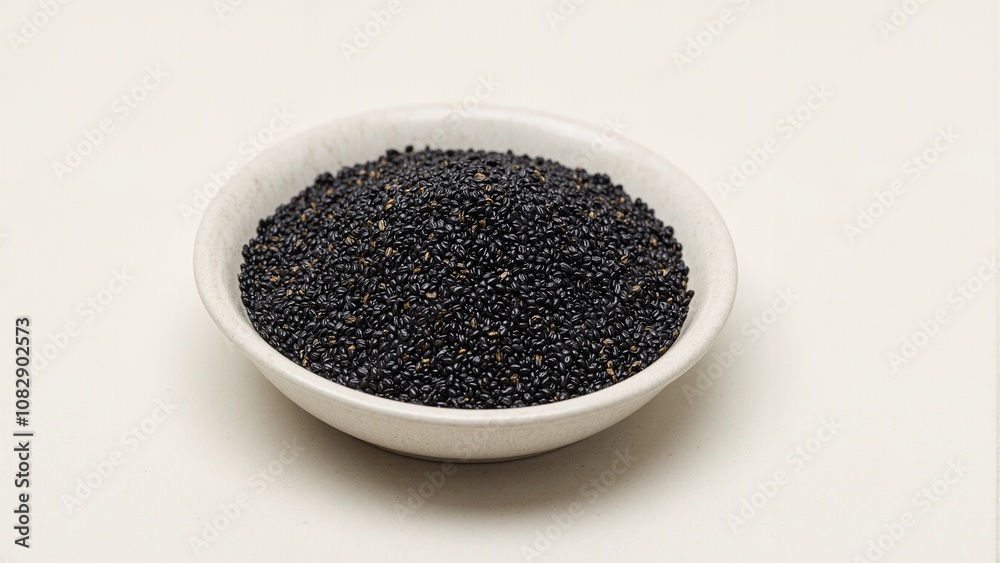 Premium black sesame seeds on ceramic surface Premium black sesame seeds on ceramic surface