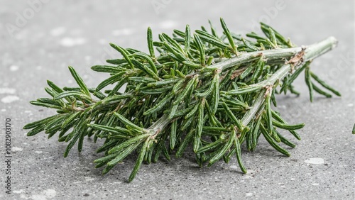 Fresh rosemary sprigs on stone surface exuding aroma