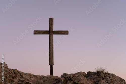 Cross on top of mountain in sunset light - background wallpaper