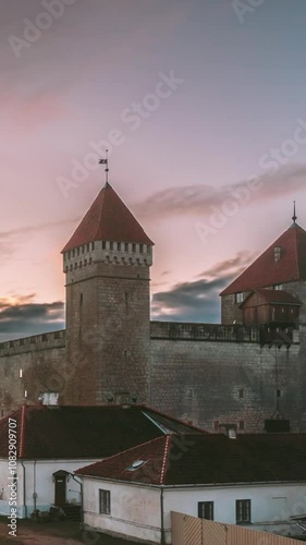 Kuressaare, Saaremaa Island, Estonia. Time-lapse, Time Lapse, Timelapse Episcopal Castle In Sunset Time. Traditional Medieval Architecture, Famous Attraction Landmark. Clouds Fast Moving In Sunny Sky photo