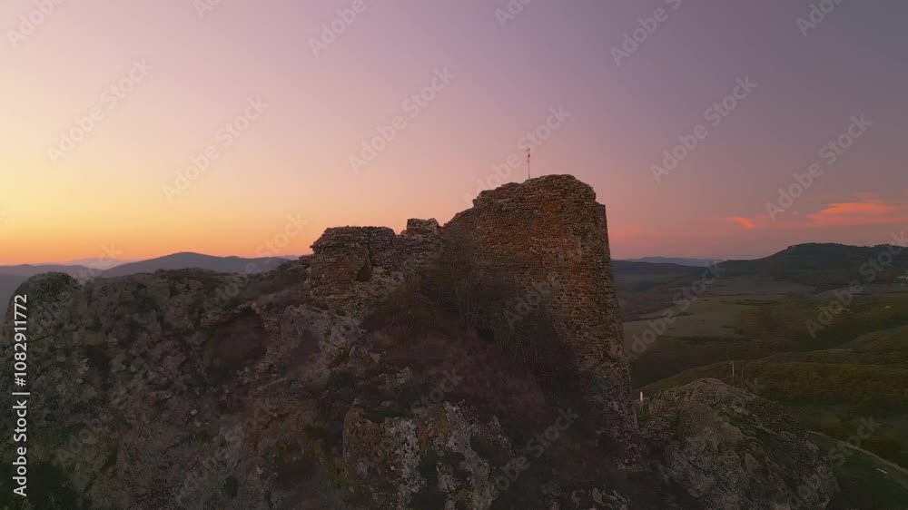 Georgian flag on top of a mountain in the evening after sunset Georgian flag on top of a mountain in the evening after sunset