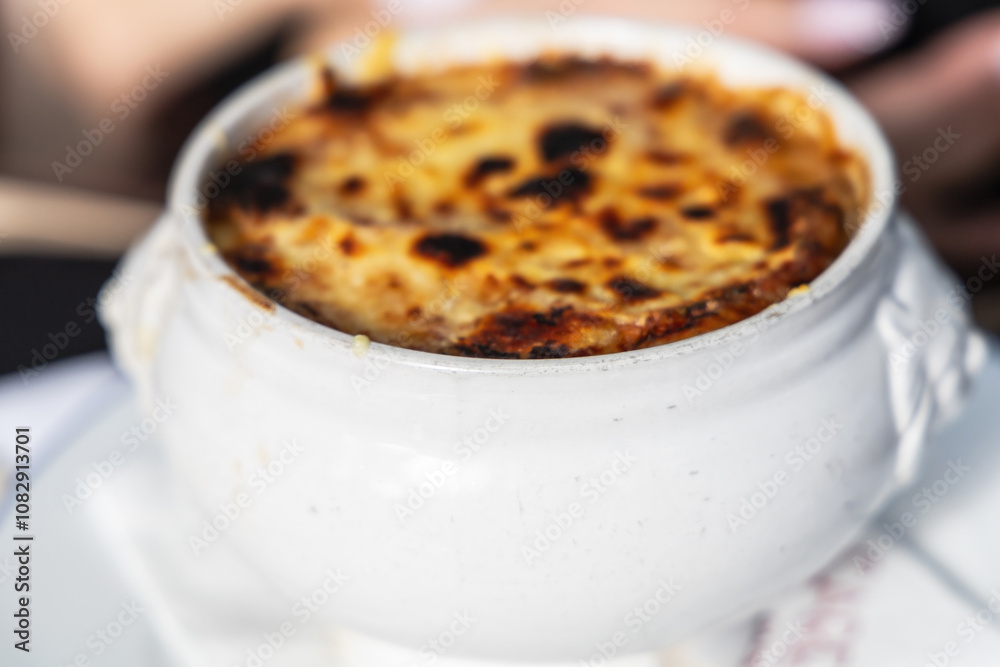 Famous french onion soup in a white pot. Famous french onion soup in a white pot.