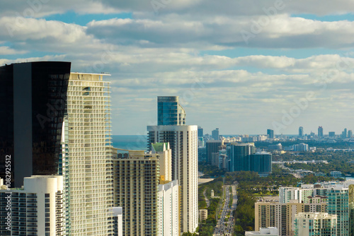 Sunny Isles Beach city with luxurious highrise hotels and condo buildings on Atlantic ocean shore. American tourism infrastructure in southern Florida photo