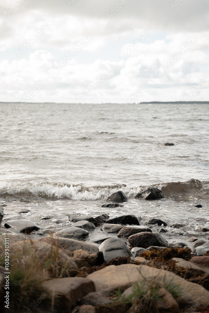 A scenic view of waves crashing against a rocky shoreline. The scene captures the raw beauty and power of nature, making it perfect for coastal and ocean-themed concepts. A scenic view of waves crashing against a rocky shoreline. The scene captures the raw beauty and power of nature, making it perfect for coastal and ocean-themed concepts.
