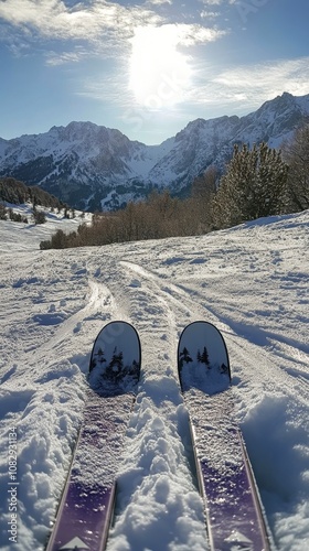 Skiing down a snow covered slope in the mountains during a clear winter after...