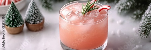 Refreshing holiday cocktail with peppermint and rosemary garnishes amidst fes...