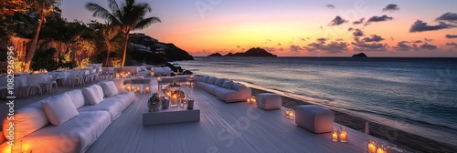 Cozy outdoor lounge with candles on a beach during sunset in a tropical paradise
