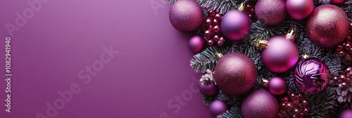 Colorful purple ornaments and stars arranged on a shimmering surface for a fe...