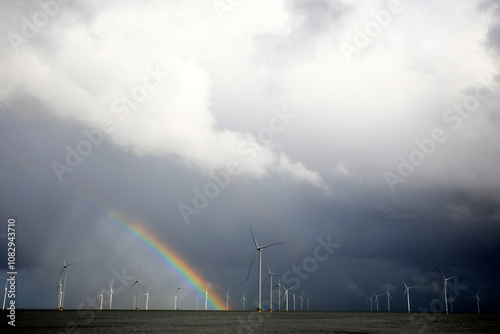 Rainbow above a offshore windpark, Breezanddijk, Holland photo