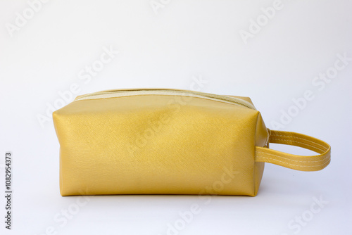 A gold-colored pencil case. This pencil case can be used to store other items such as cosmetics, electronic devices, gadgets, and etc. photo