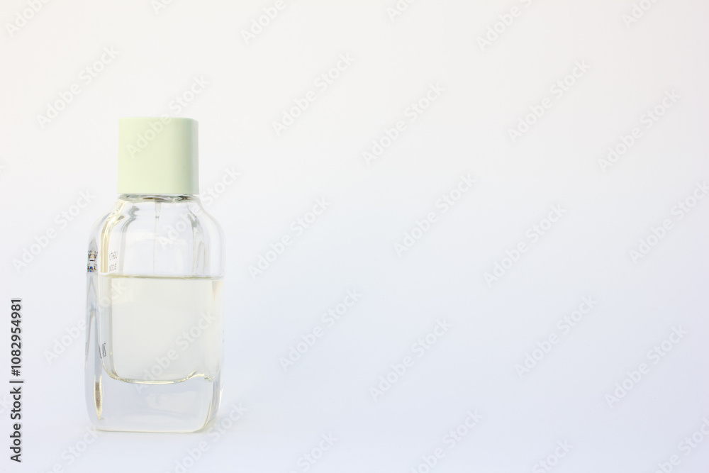 This artistic image presents a single, luxurious perfume bottle against a soft-focus background. This artistic image presents a single, luxurious perfume bottle against a soft-focus background.