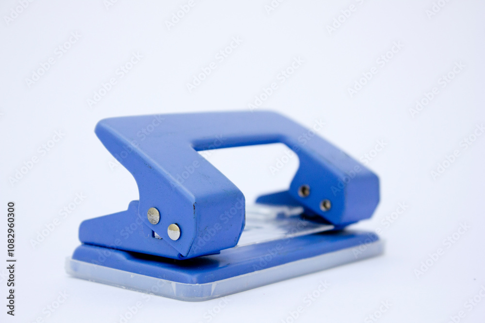 Paper Punch with Two Holes: A close-up shot of a paper punch that creates two evenly spaced holes, ideal for educational or tutorial content related to paper crafting and office supplies. Paper Punch with Two Holes: A close-up shot of a paper punch that creates two evenly spaced holes, ideal for educational or tutorial content related to paper crafting and office supplies.
