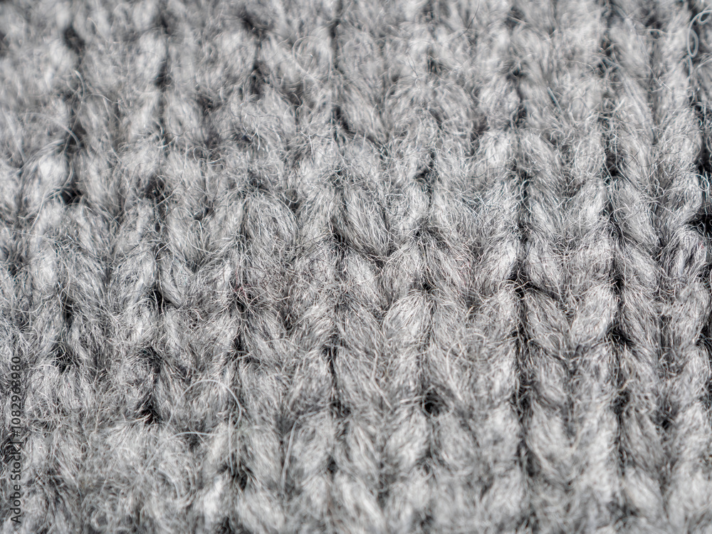 A textured gray knitted fabric ideal for cozy pieces and stylish clothing A textured gray knitted fabric ideal for cozy pieces and stylish clothing