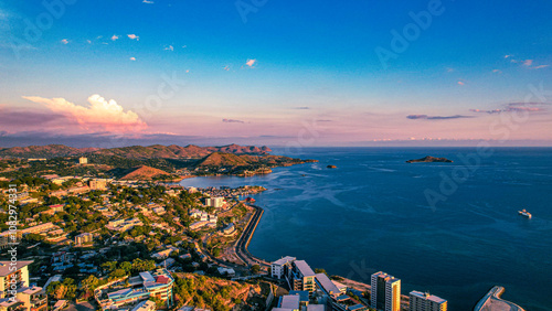 Beautiful view of Port Moresby South from above with the fish market and houses over the water and windward apartments in the foreground during sunrise