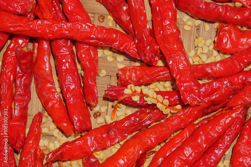 Dried red chilies with exposed chili seeds. Chilies are being dried in the sun to make seeds. Abstract shapes, patterns and techniques. related to the agricultural sector photo