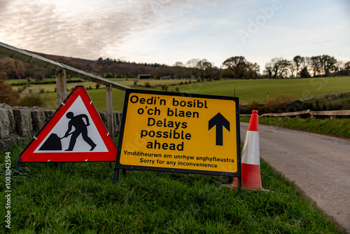 Road works sign announces possible delays in welsh and english languages