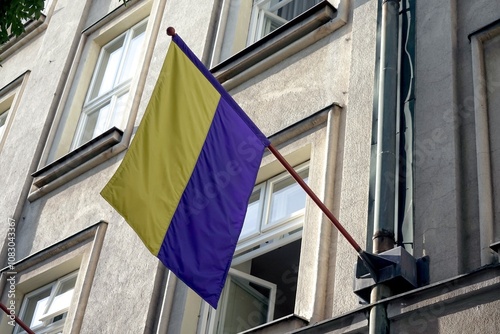 Flag of Czech Pisek city on building, blue and yellow stripes photo