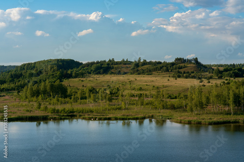 View of the Izborsko-Malskaya Valley and Gorodishchenskoe Lake on a sunny summer day, Izborsk, Pechersk district, Pskov region, Russia photo