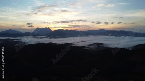 Beautiful sea of white mist covers the valleys and mountain in the morning 