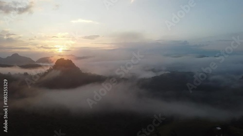 Beautiful atmosphere of white mist covers the valleys and mountain in the morning light