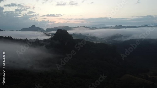 Beautiful atmosphere of white mist covers the valleys and mountain in the morning