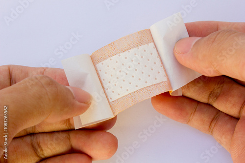 An adhesive bandage, also known as a sticking plaster or medical plaster, is a small, flexible sheet of material with a sticky side and a non-sticky, absorbent pad. 