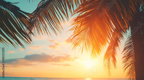 Serene sunset over the ocean with palm trees framing the vibrant sky on a peaceful evening