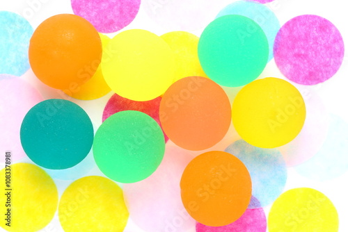 Coloured rubber ball on polka dot background Shallow depth of field Rubber ball is semi translucent photo