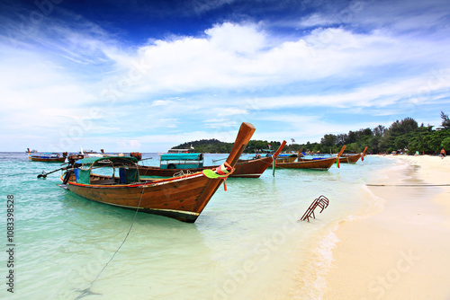 Traditional Thai Long tail boats moored on the Lipe beach, at lipe island. Satun Province Thailand photo