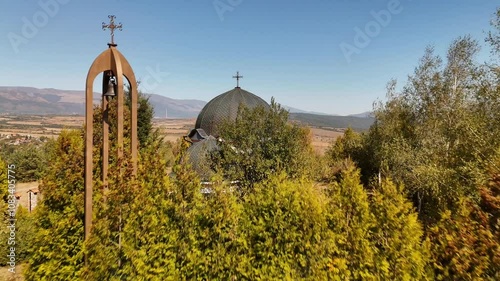 Drone footage of Saint Petka Chapel on a sunny day in the village of Chavdar, Sofia, Bulgaria photo