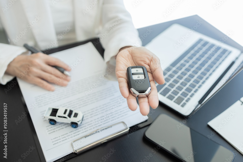 Fototapeta premium Close-up of Asian businesswoman making a contract for car rental or car purchase
